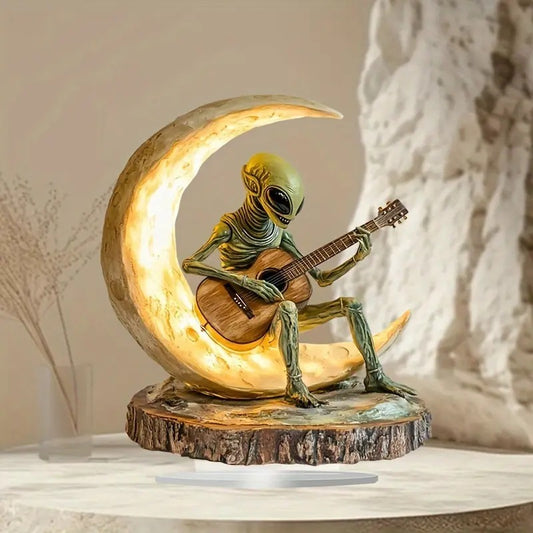 Sculpture extraterrestre jouant de la guitare
